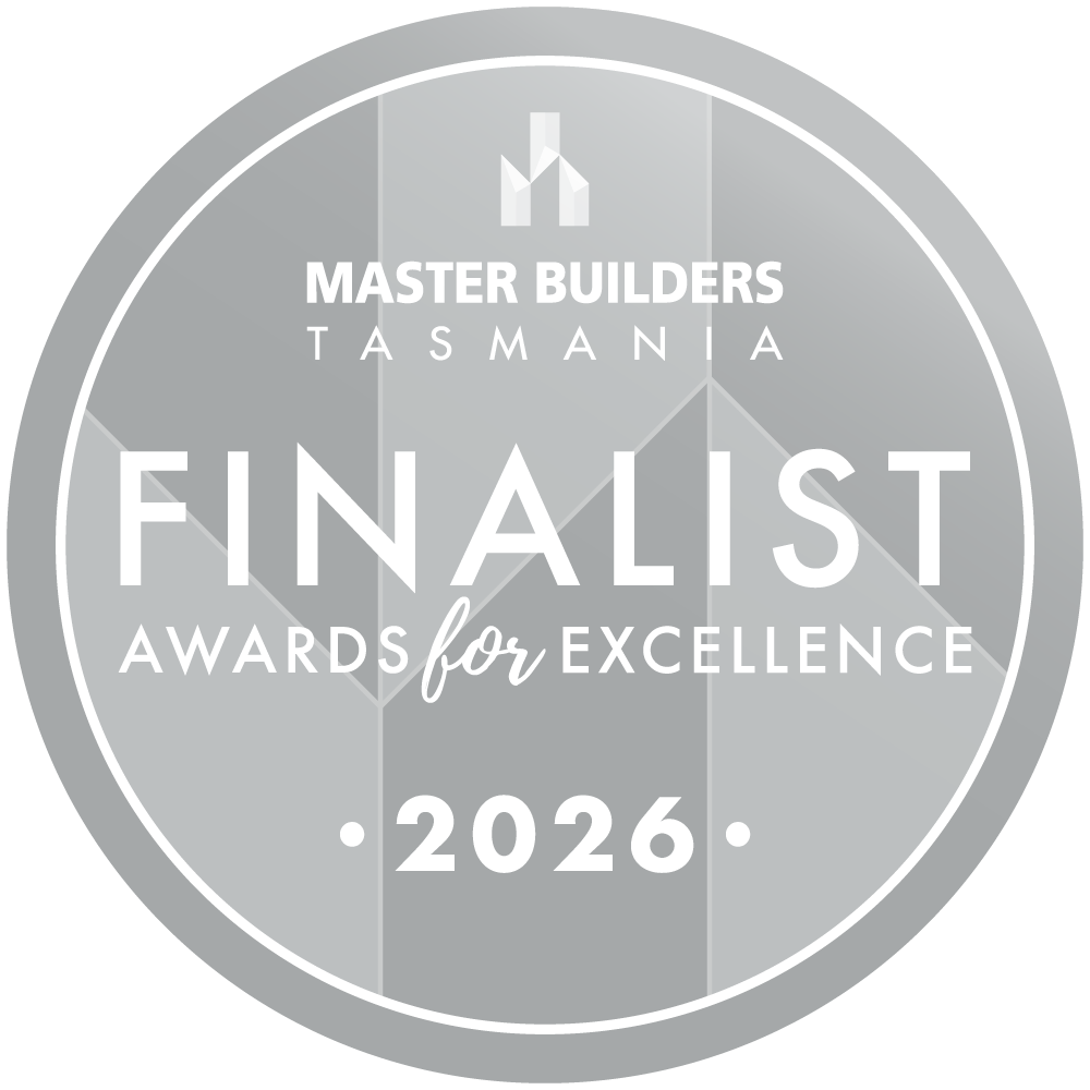 Silver round badge with text: Master Builders Tasmania Finalist Awards for Excellence 2026 on geometric background.